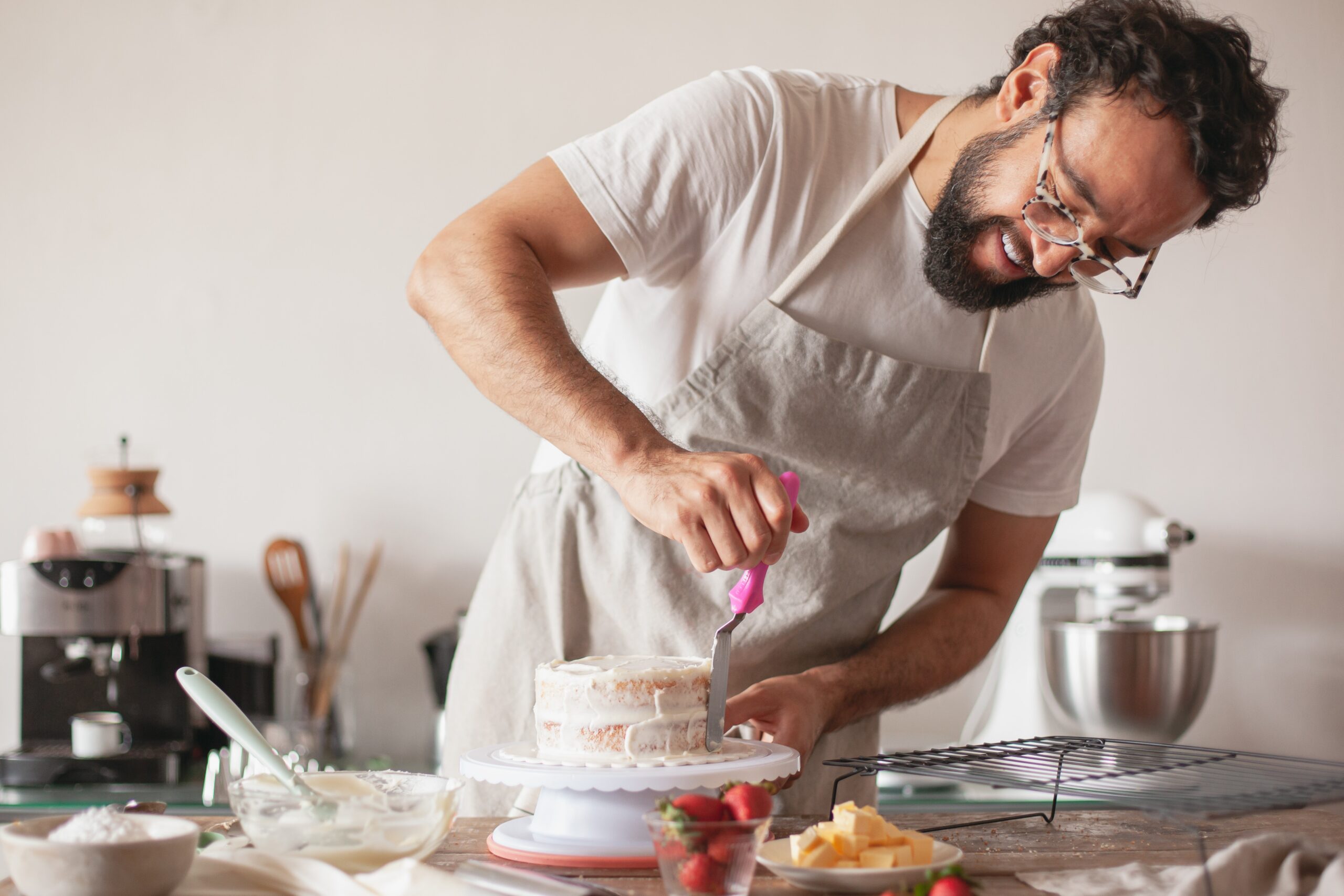 a baker making a cake in a kitchen
