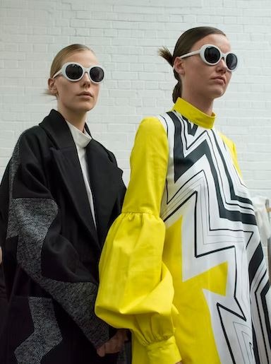 Man in black and yellow jacket wearing sunglasses