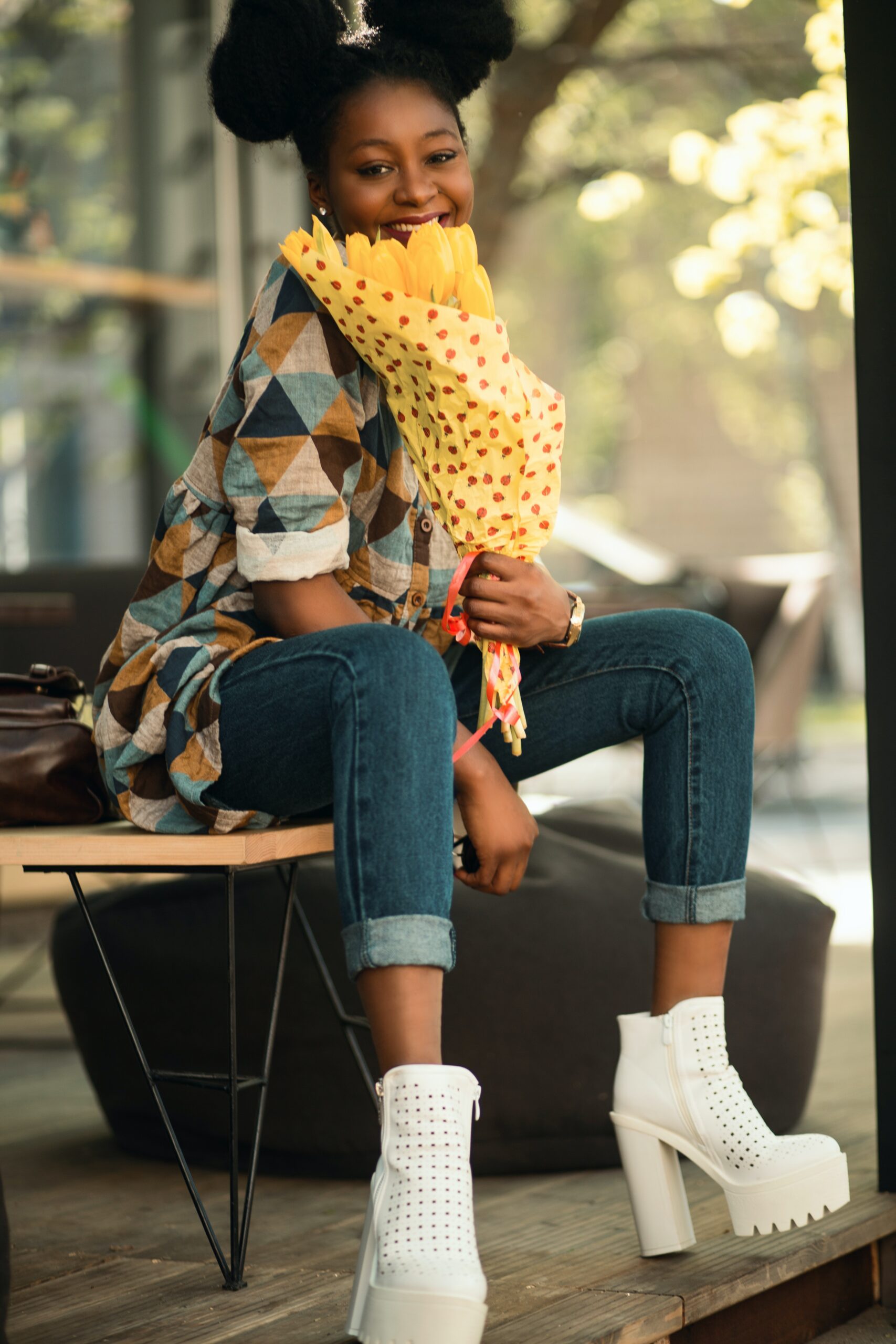 A woman wearing a dress over a jeans
