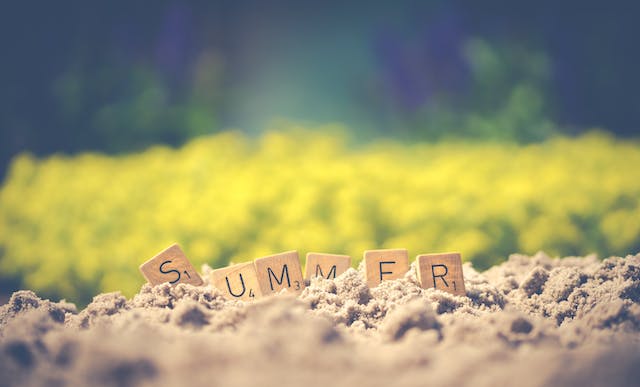 Word Summer spelled on the sand