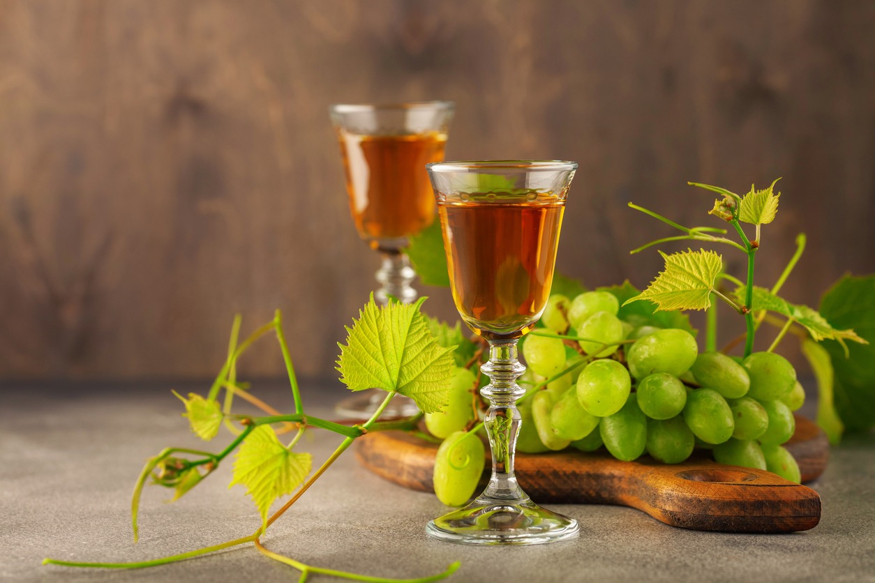 Glass of grappa and fresh grapes