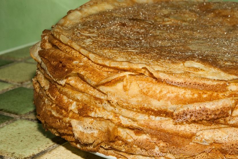 a stack of crêpes topped with sugar