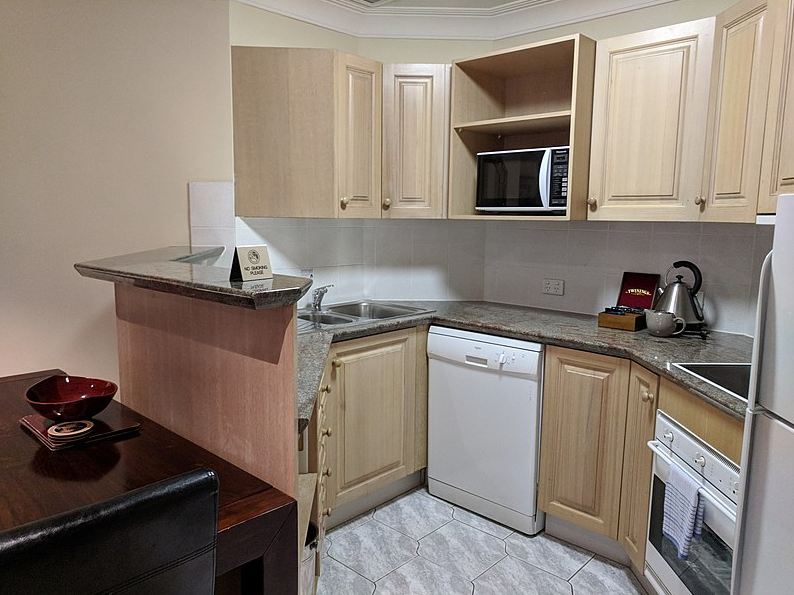 A hotel room with a kitchen
