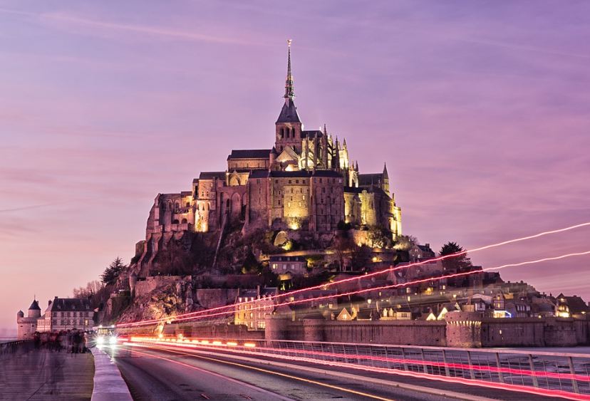 Mont-Saint-Michel, a big structure, purple sky, purple lights