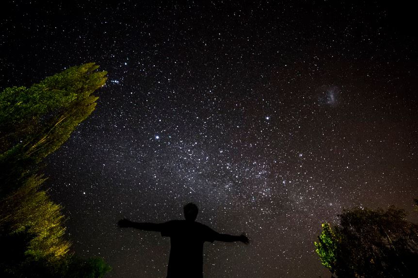 A photo of a person looking at the night sky
