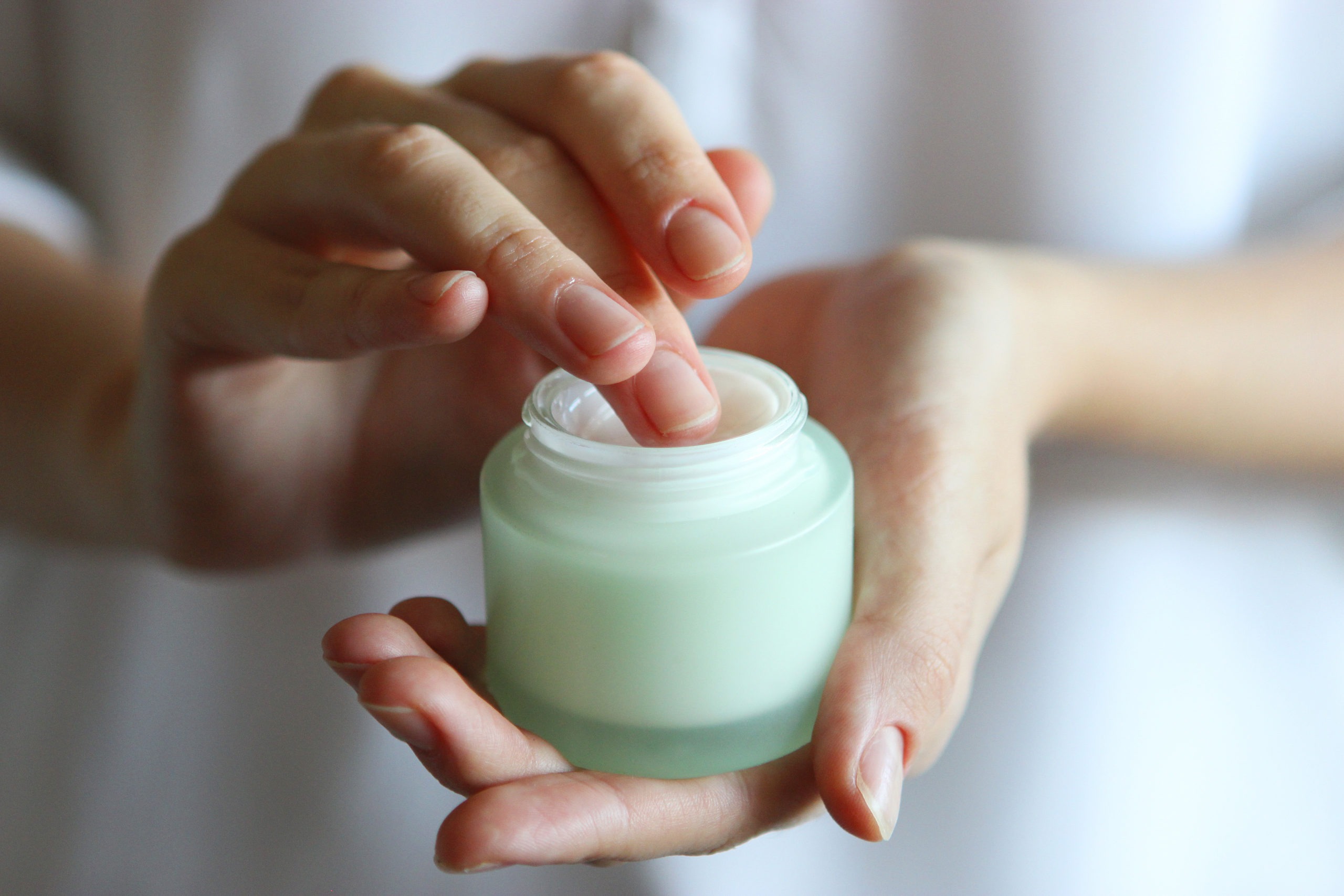 girl uses hand cream. Skin care, skin hydration.