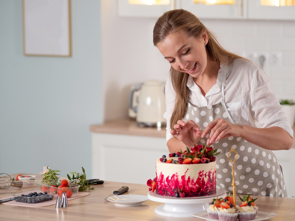 woman decorating a cake