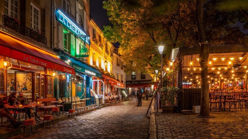 different-French-cafes-and-restaurants-tall-green-trees-yellow-lights-and-bright-streetlights