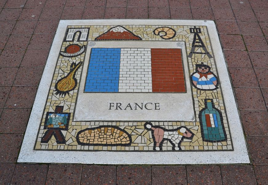 square-insignia-on-a-pavement-showing-the-name-‘France-and-its-flag-at-the-center-surrounded-by-all-other-symbols-unique-to-France-